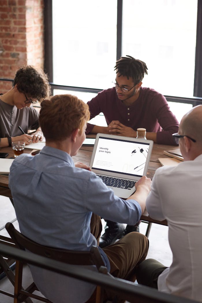 Crafting Captivating Headlines: Your awesome post title goes here Four adults collaborate in a bright office for project research and brainstorming.